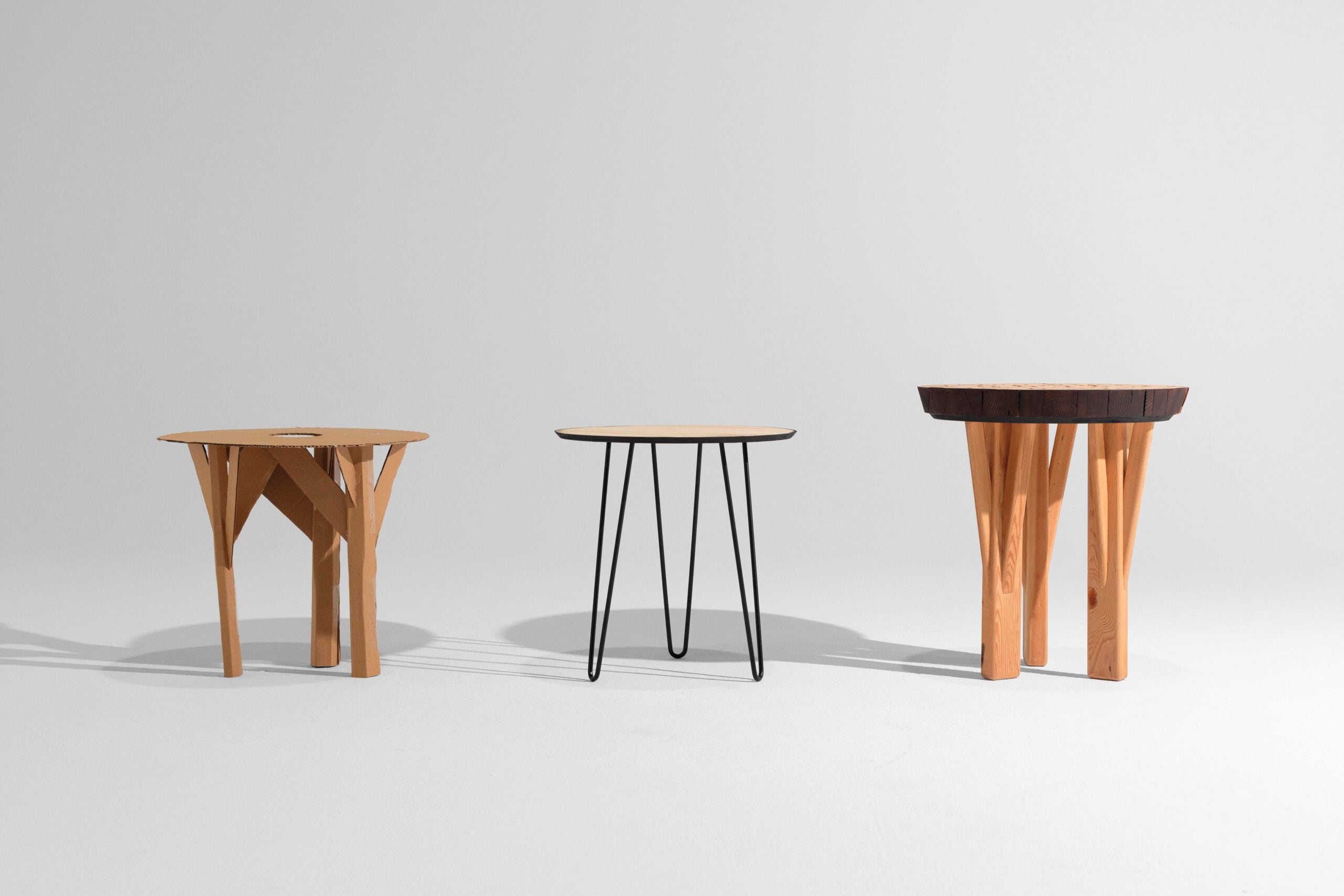 Three tables in a line, each made with salvaged wood.