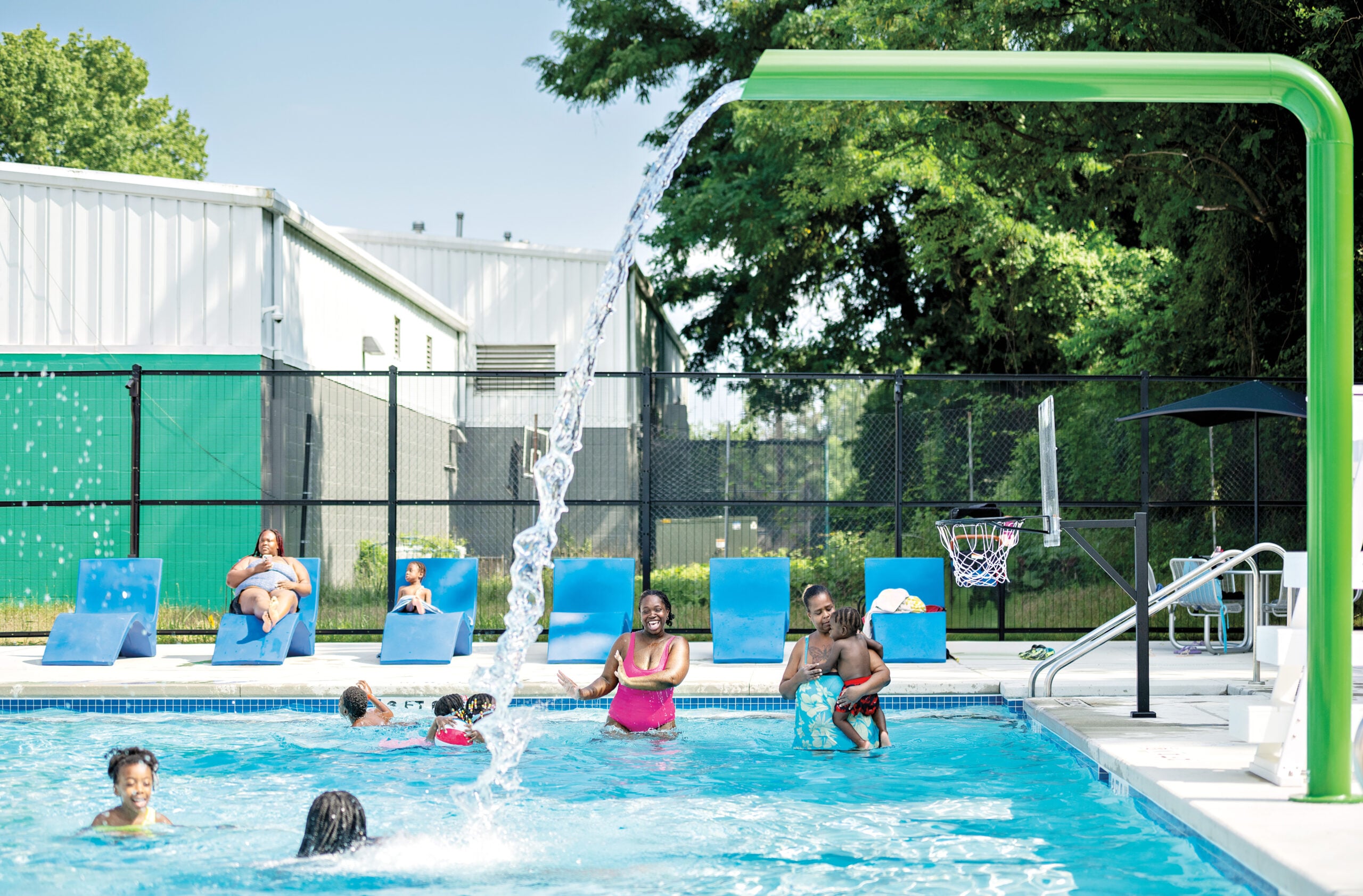 Baltimore pool with bright blue lounge chairs, enjoyed by family in play