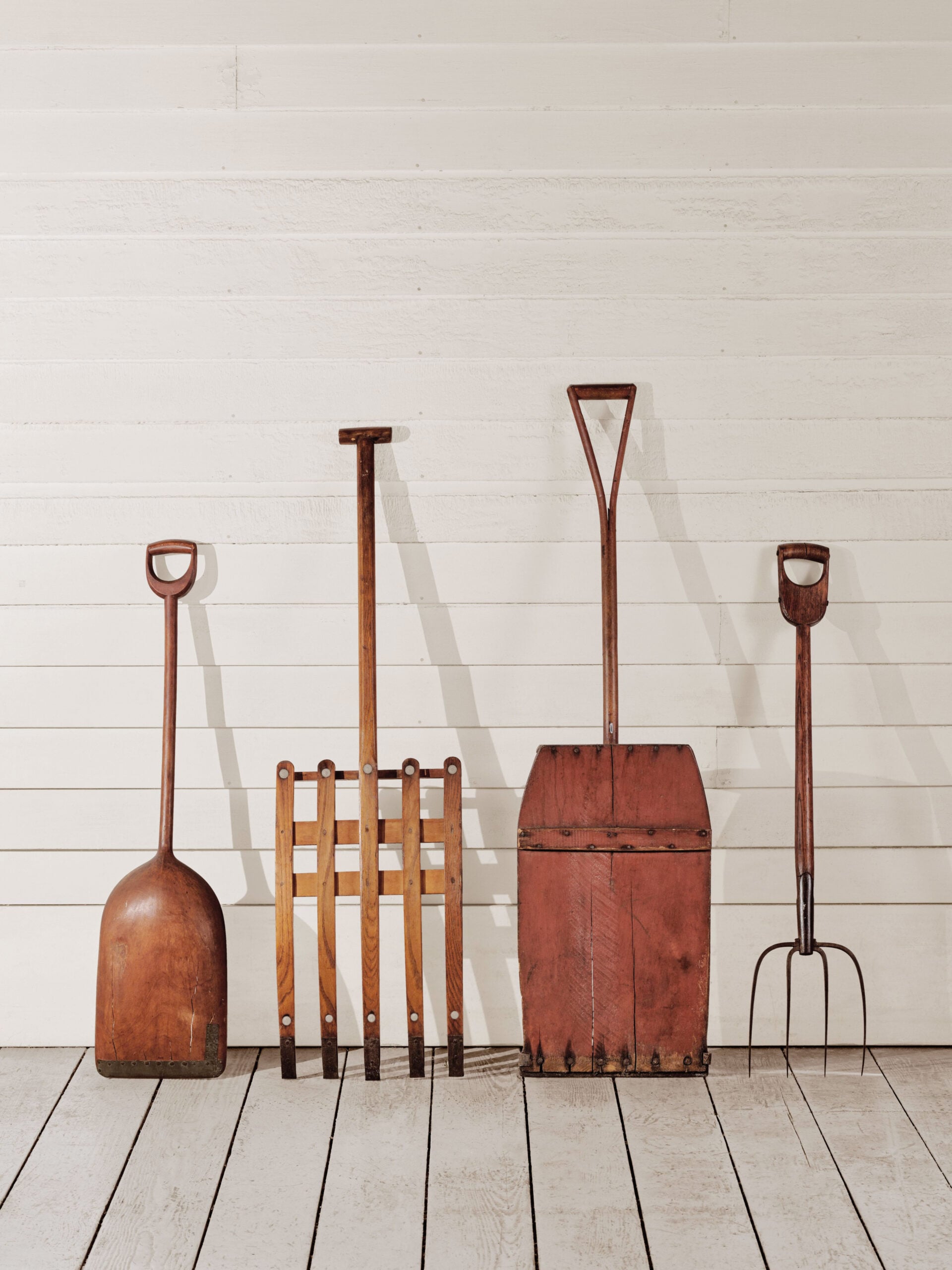 Wooden agricultural tools made by Shakers leaning against wall