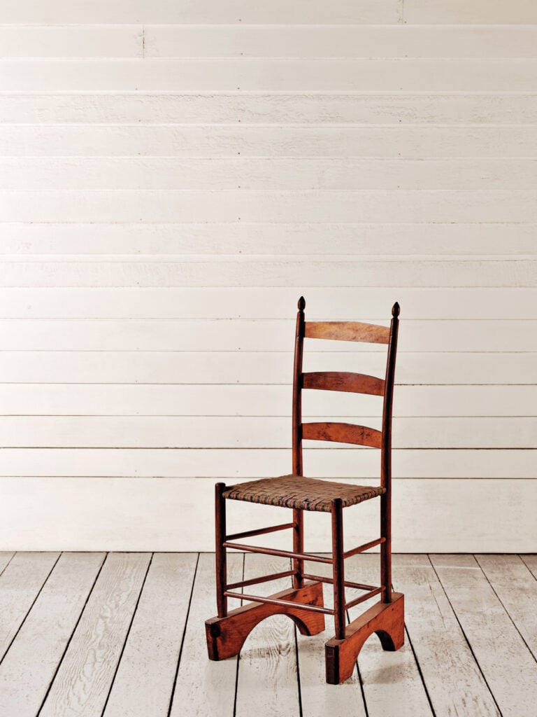 Wooden chair with tall wood blocks on the base, made by Shakers