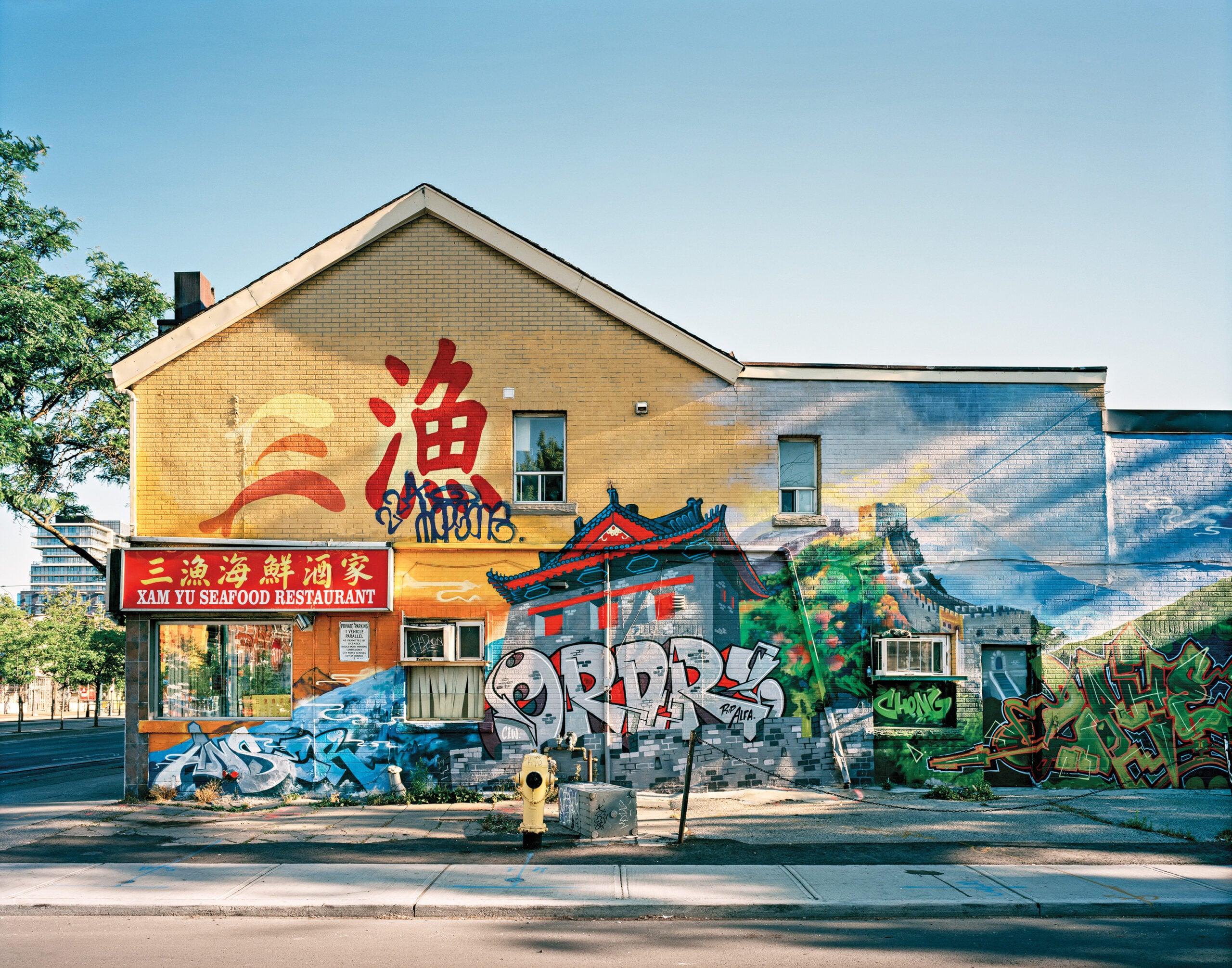 Xam Yu Seafood Restaurant with graffiti and murals on the side.