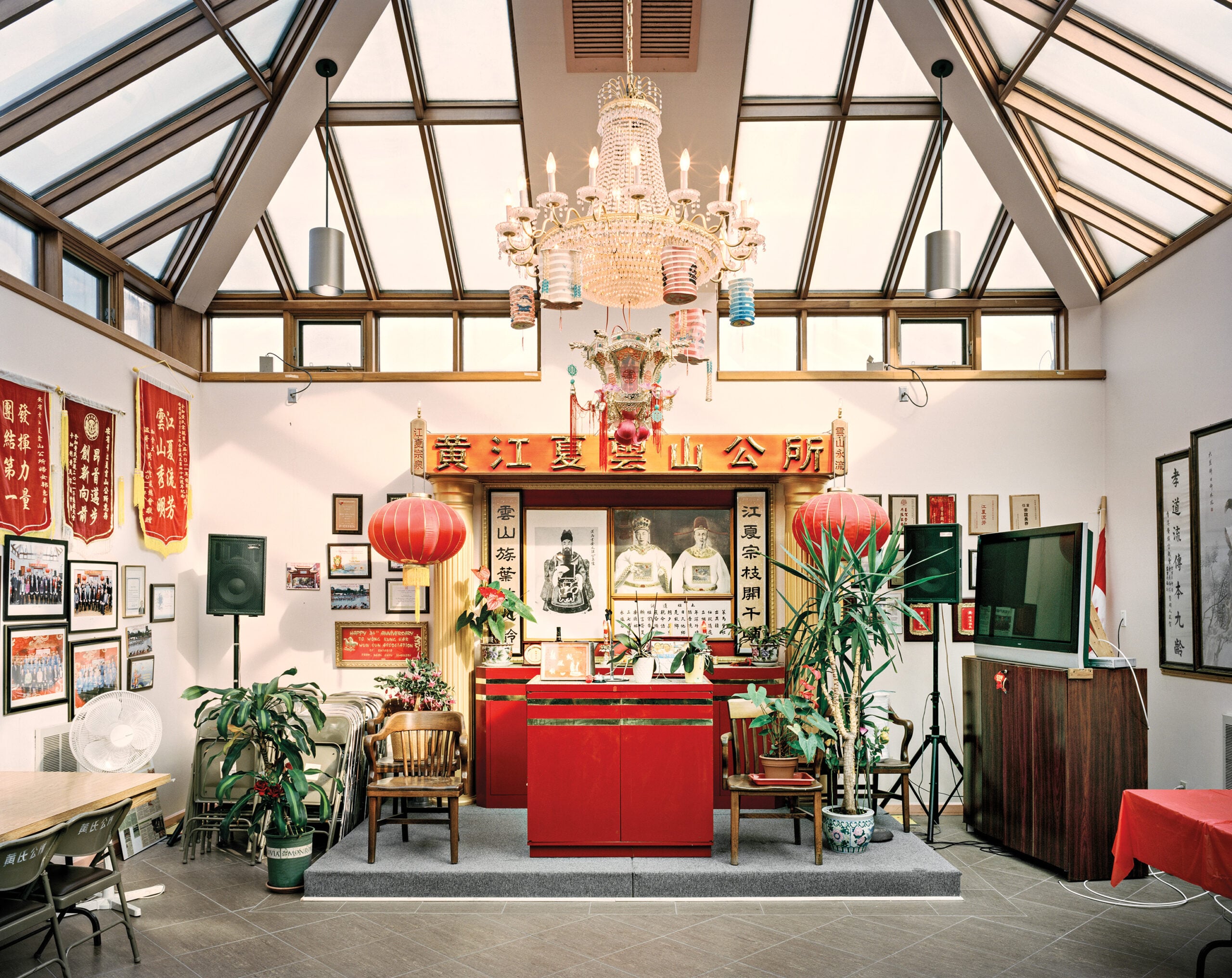 A brightly lit interior of a cultural or community hall decorated in traditional Chinese style.