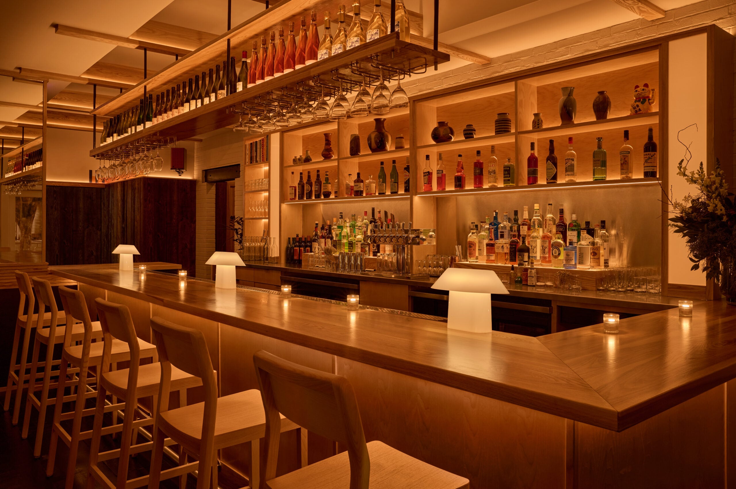Warm lighting on a wooden restaurant bar at Banshee Restaurant 