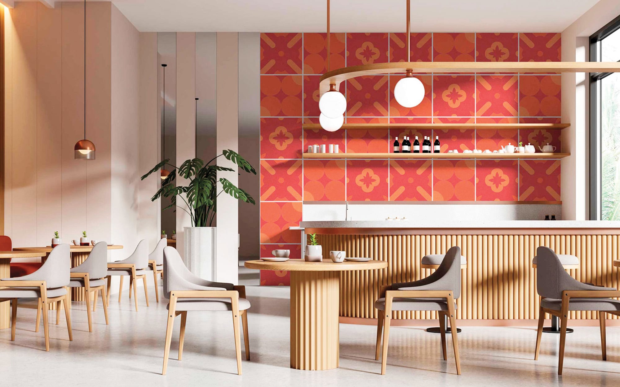 Modern café interior with red patterned wall tiles, wooden furniture, round tables, gray chairs, large windows, and pendant lights. Bottles and cups are arranged on shelves behind the counter.