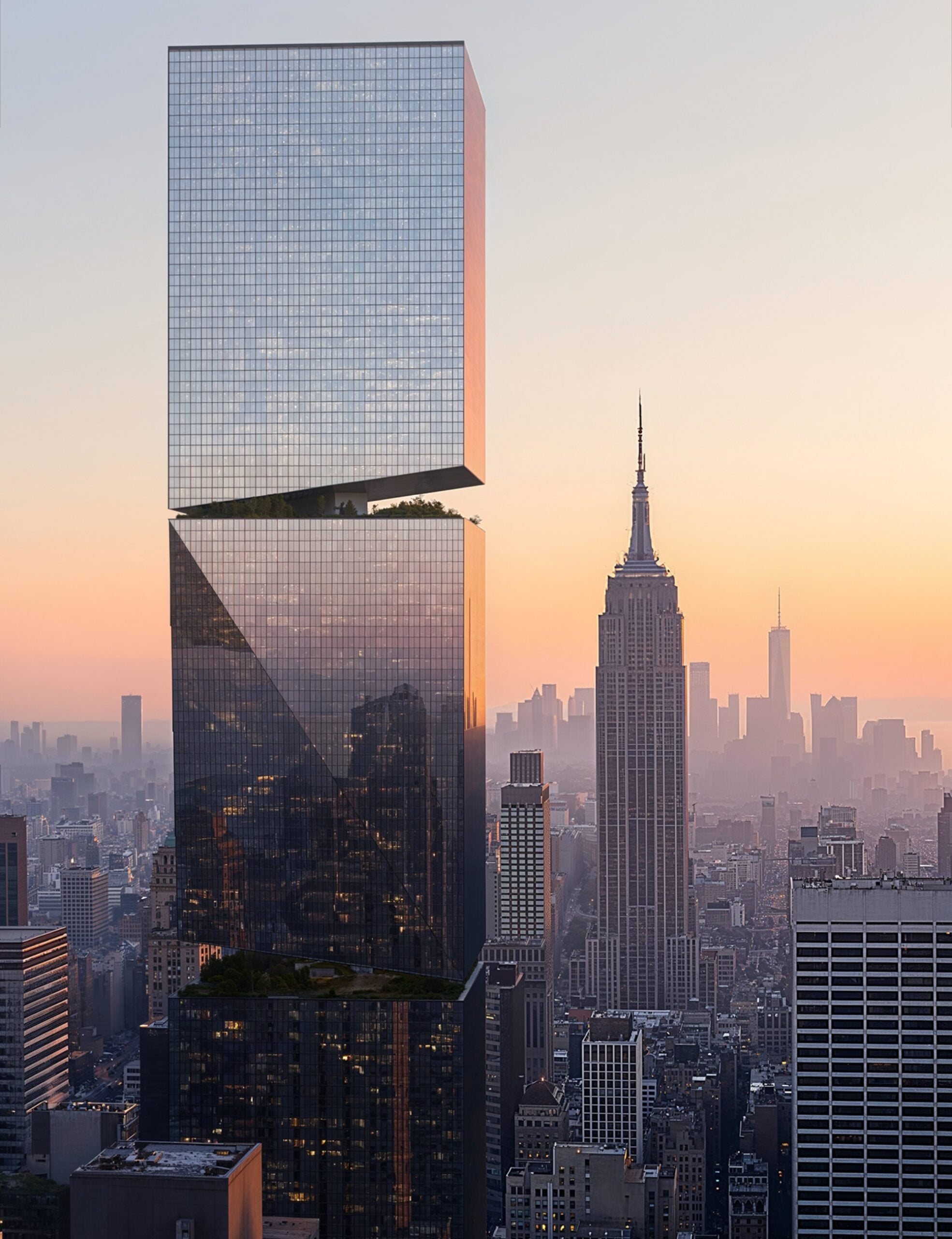A modern glass skyscraper with two offset rectangular sections stands among other buildings at sunset, featuring sleek Wolf-Gordon finishes, with the Empire State Building in the background.