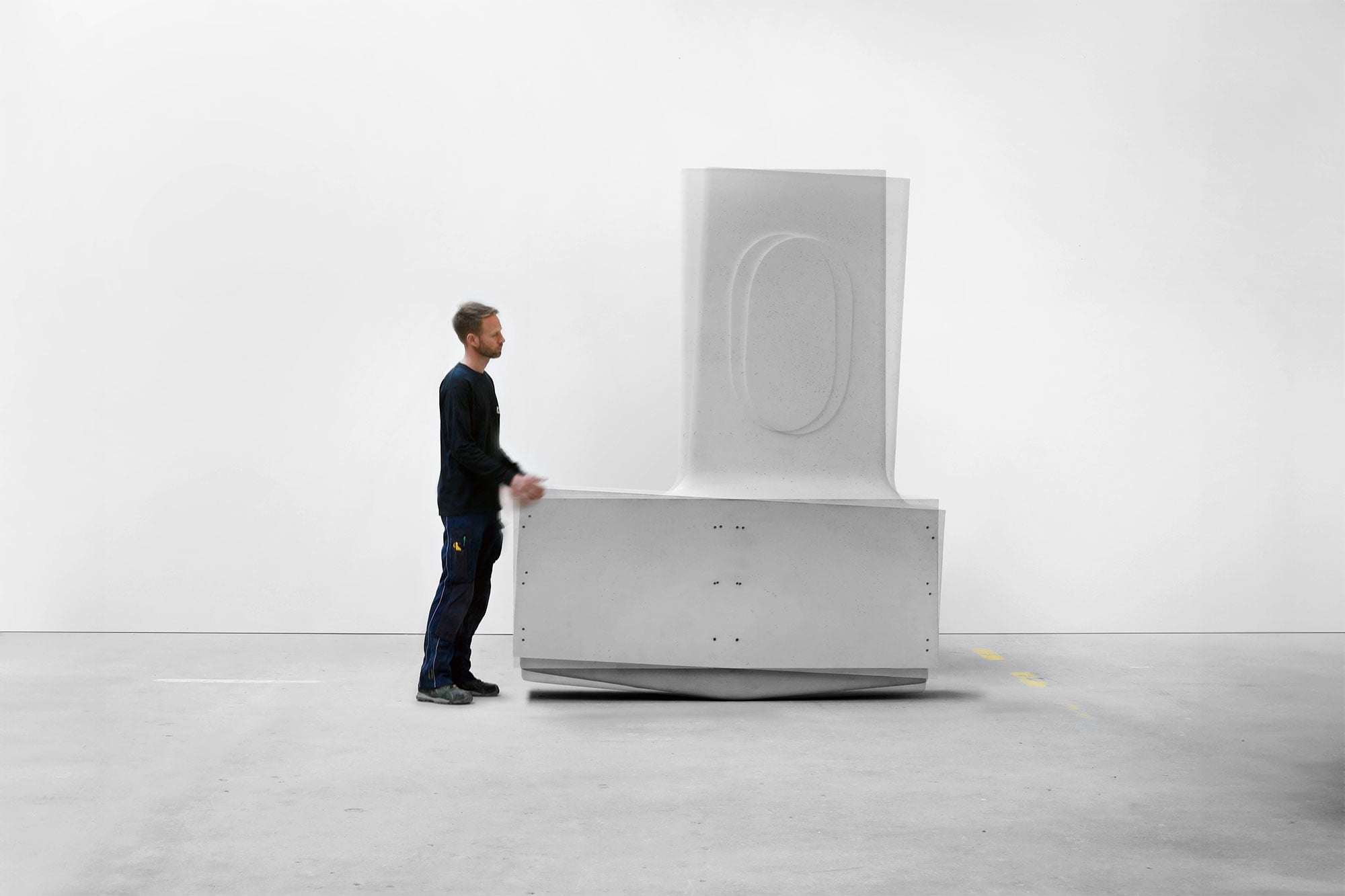 A man stands next to a large, white, geometric sculptural object in a minimal, empty room with a plain white wall, evoking the clean lines and harmony of organic architecture.