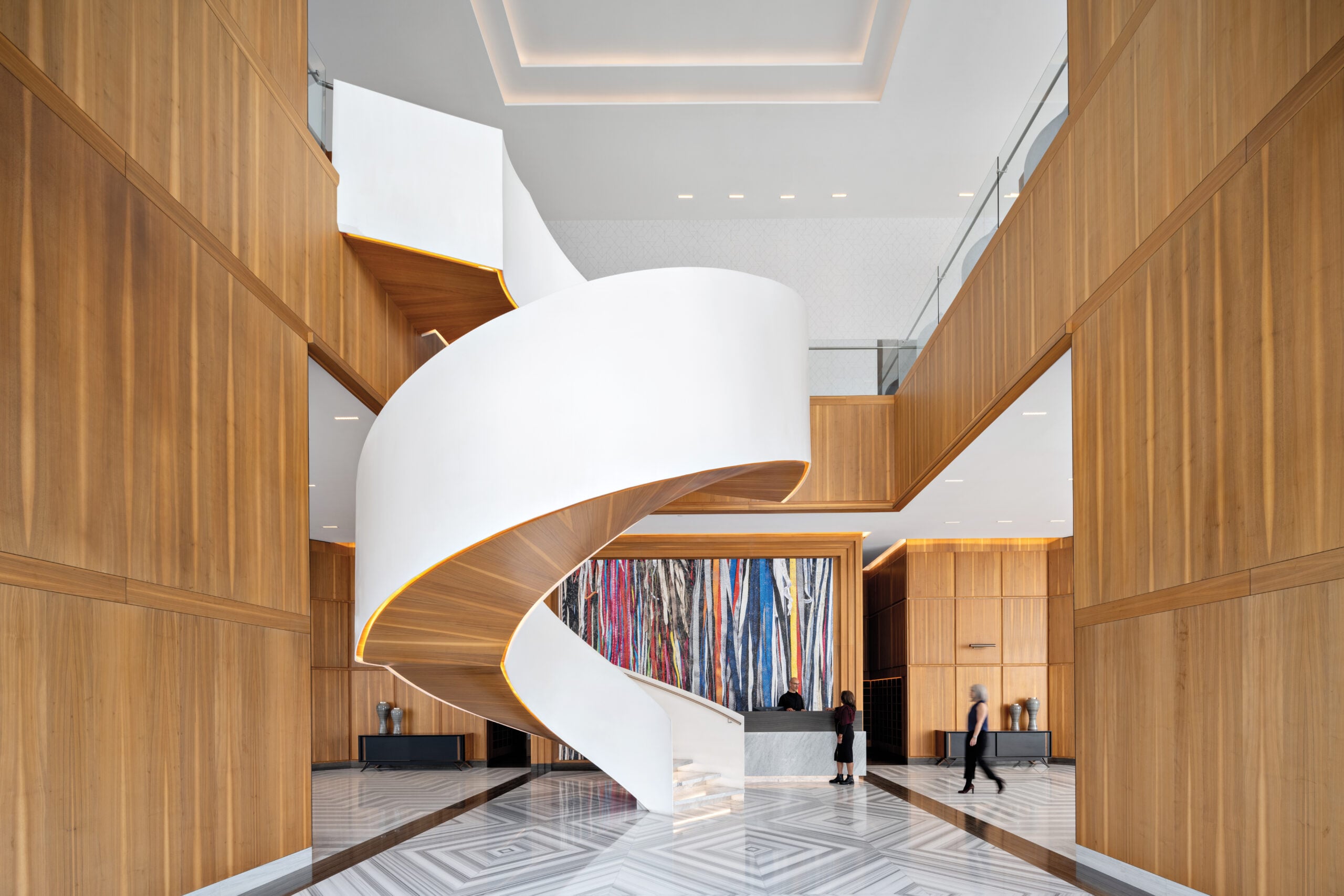 Wooden retail interior with striking white spiral staircase that showcases craft in architecture.