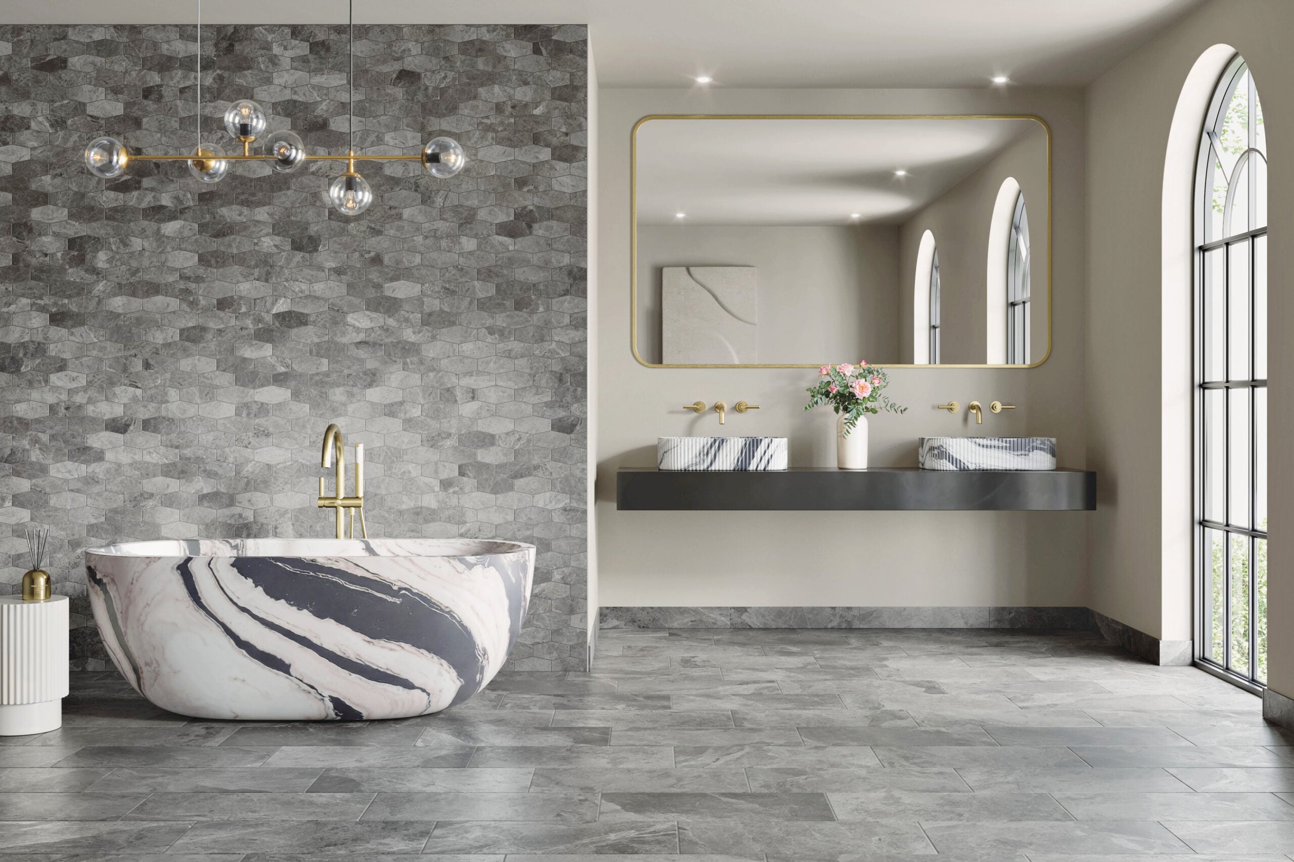 Modern bathroom with a marble-patterned bathtub, gray tiled walls and floors, double sink vanity with a large mirror, pendant lights, and arched windows letting in natural light—an oasis worthy of METROPOLISLikes.