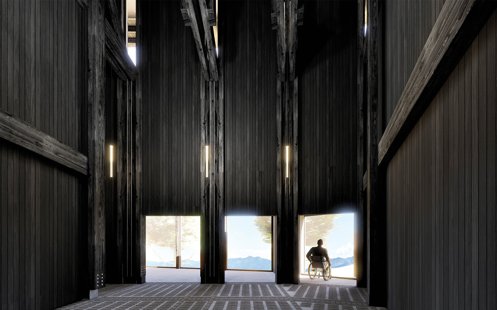 A person in a wheelchair faces large vertical windows in a tall, dark wood interior with exposed beams and natural light streaming in.
