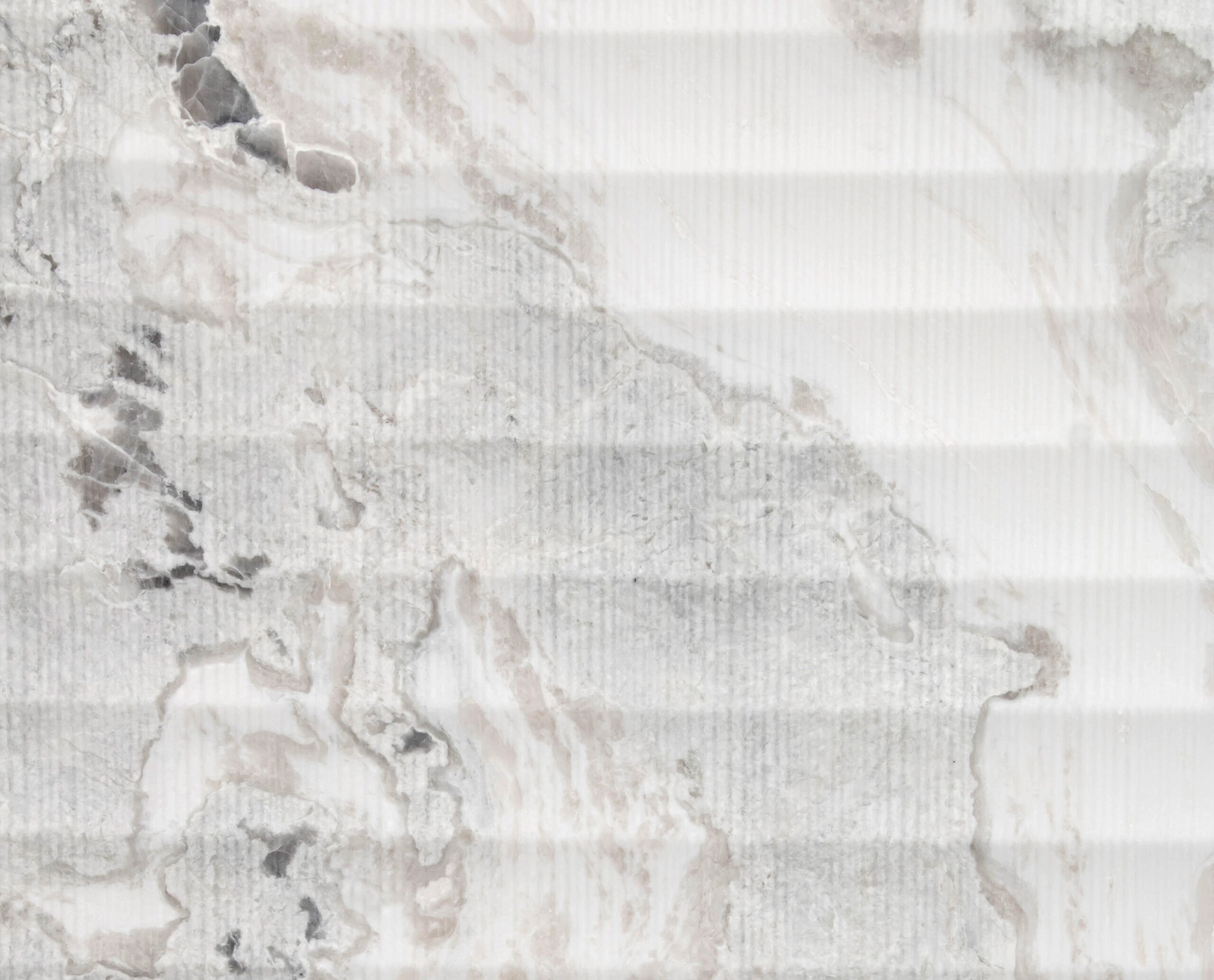 Textured surface with a gray and white marbled pattern, featuring horizontal ridges and subtle beige accents throughout.
