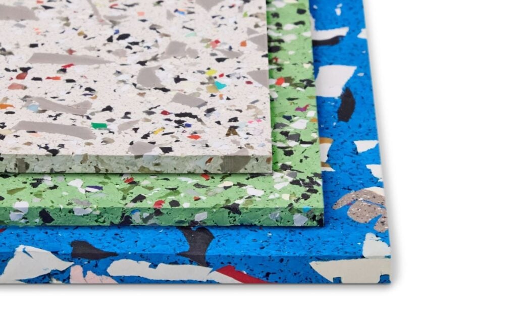 Three stacked rectangular sheets of terrazzo material in white, green, and blue, each with colorful stone and chip patterns, perfect for elevating your Office Products collection, set against a white background.