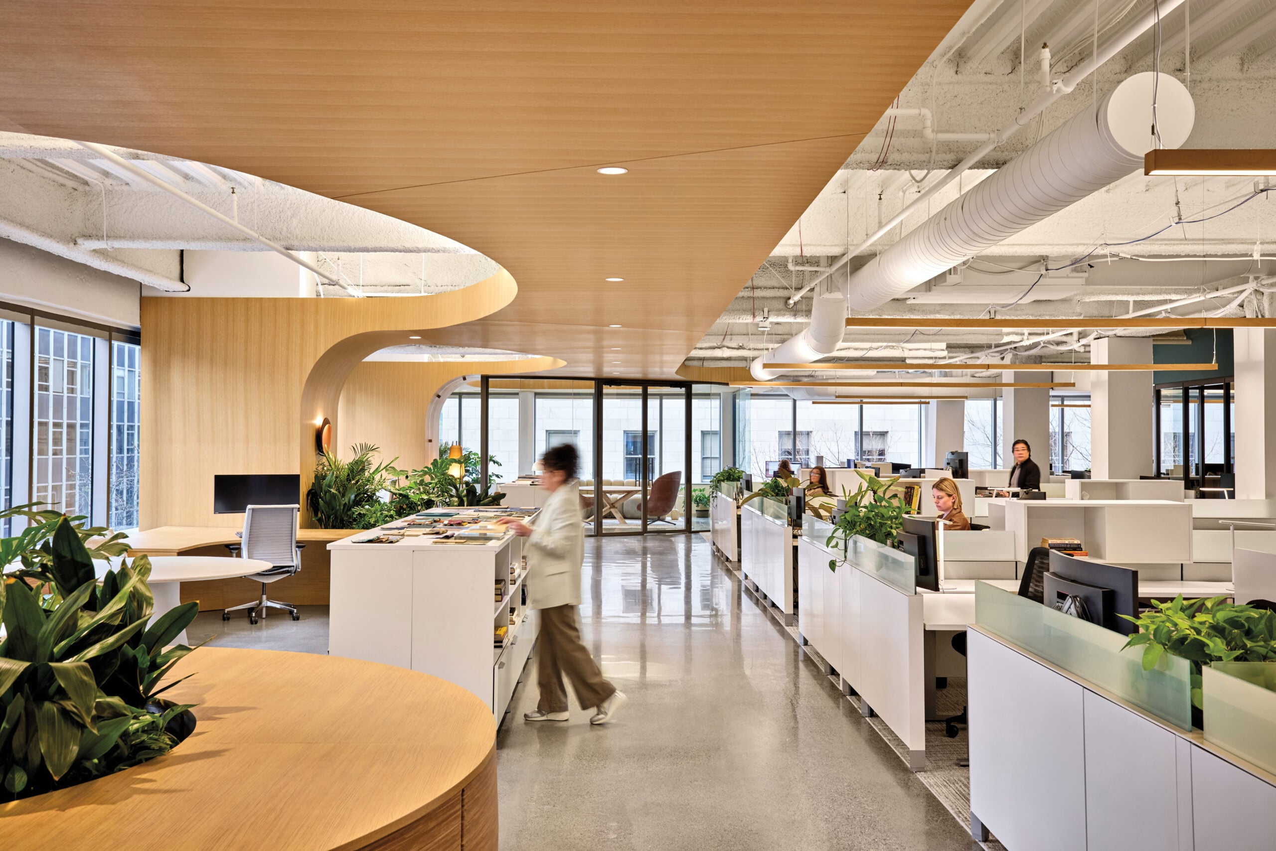 Modern Seattle office interior with wood accents, communal worktables and workplace seating.