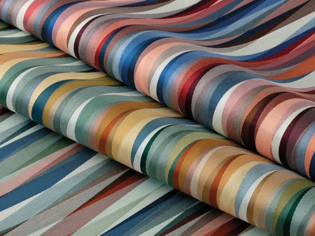 Two rolls of fabric with wavy, multicolored striped patterns in various shades, arranged parallel to each other—a vibrant addition to any METROPOLISLikes collection.