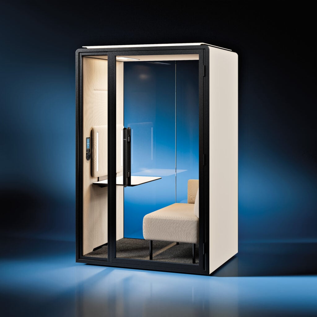A modern office phone booth with glass walls, a small desk, a chair, and an interior light stands against a gradient blue and black background—an ideal spot for METROPOLISLikes seeking style and privacy.