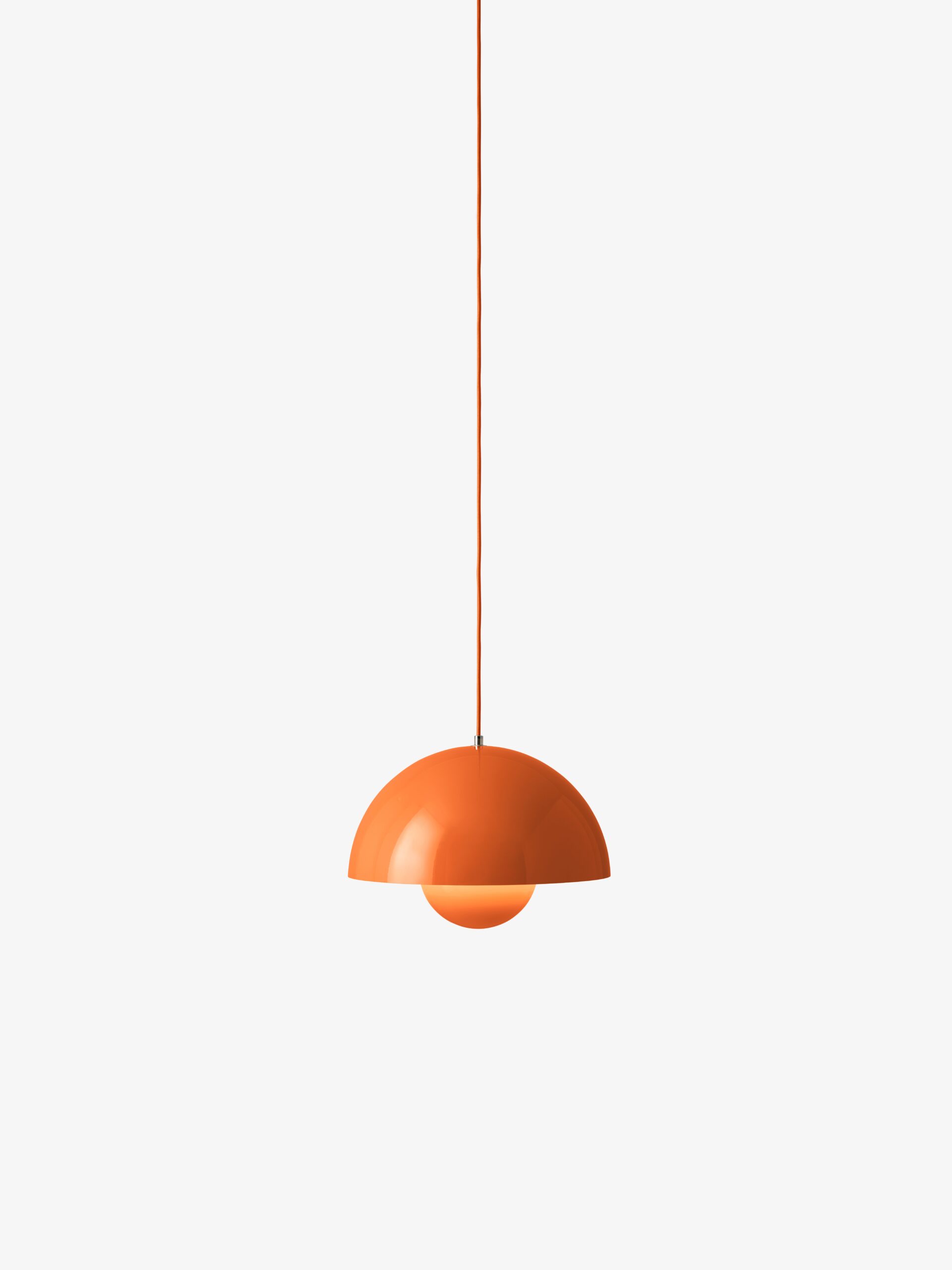 Neuro-Inclusive Lighting: Orange dome-shaped pendant light with a matching orange cord hangs against a plain white background.