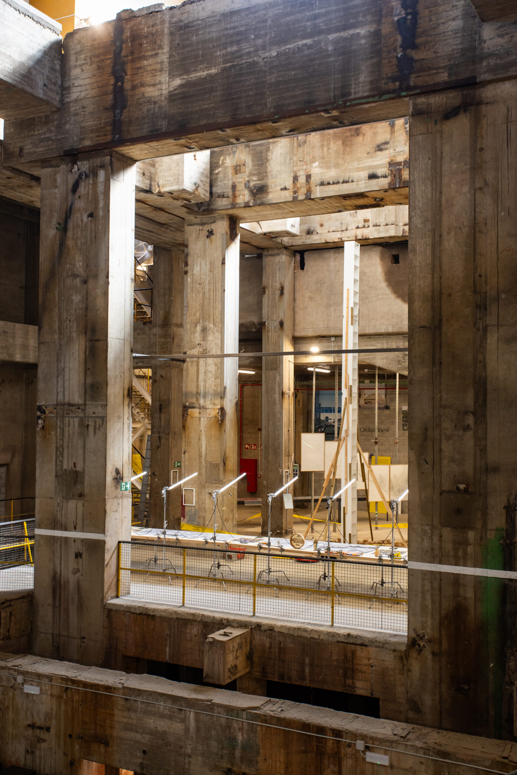 Interior of a large, unfinished concrete structure with exposed beams, scaffolding, and yellow safety railings under natural light—perfectly capturing the raw energy showcased during 3daysofdesign.
