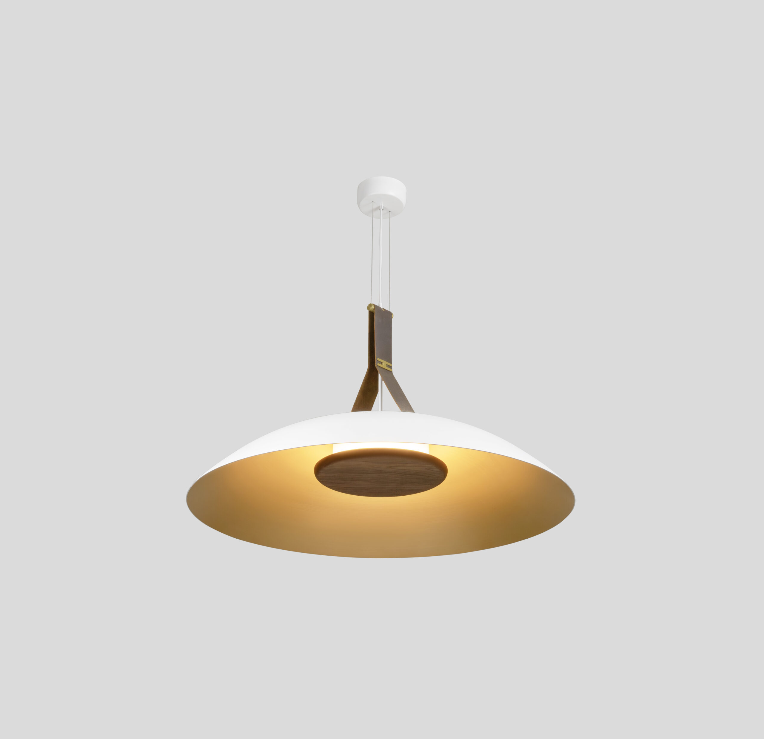 Neuro-Inclusive Lighting: Modern pendant light with a wide, white and gold dome-shaped shade, suspended from the ceiling by two brown straps and a central fixture, against a plain gray background.