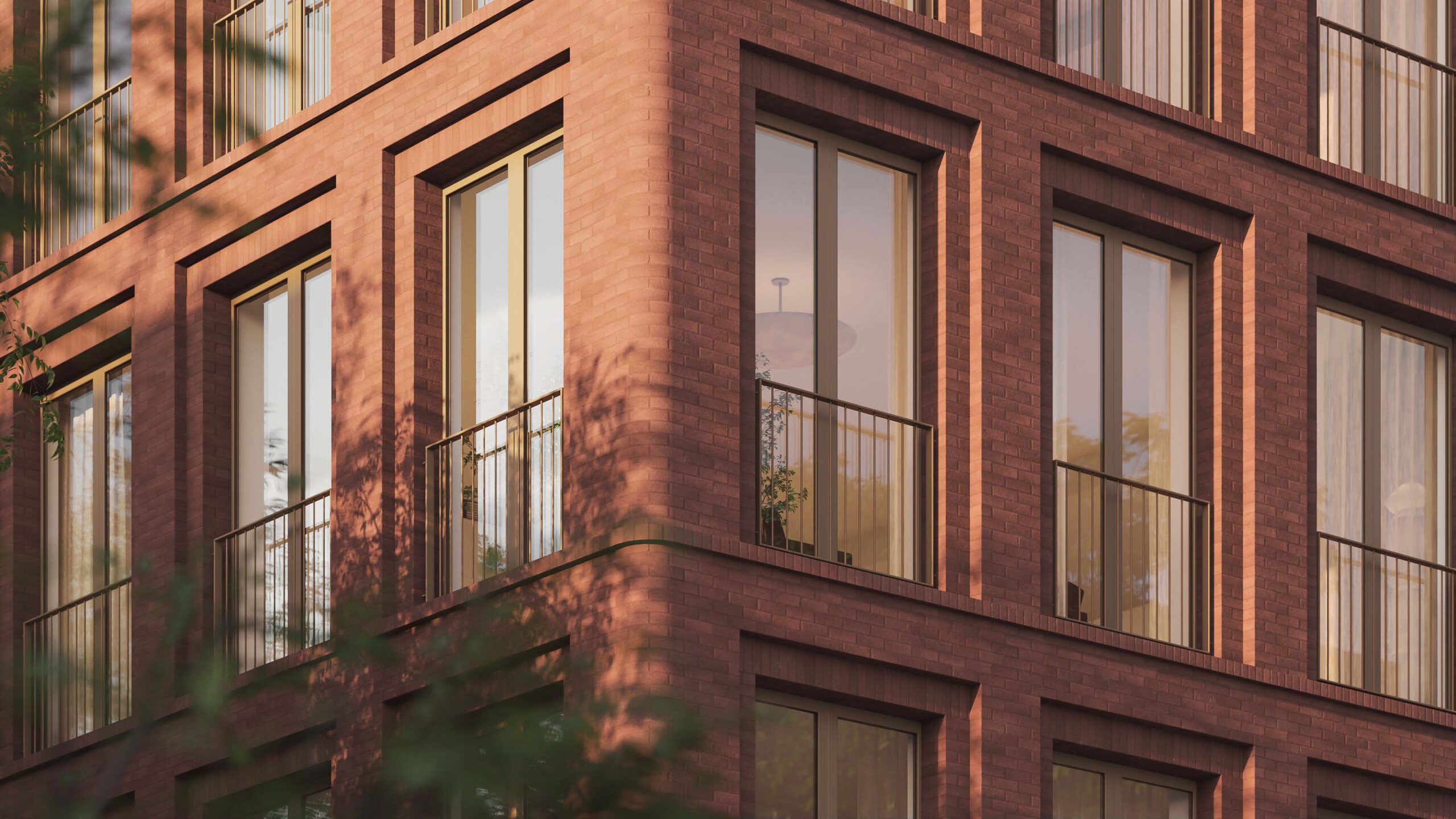Corner view of a modern Avdoo brick apartment building with large windows and metal railings, reflecting sunlight and surrounding trees.