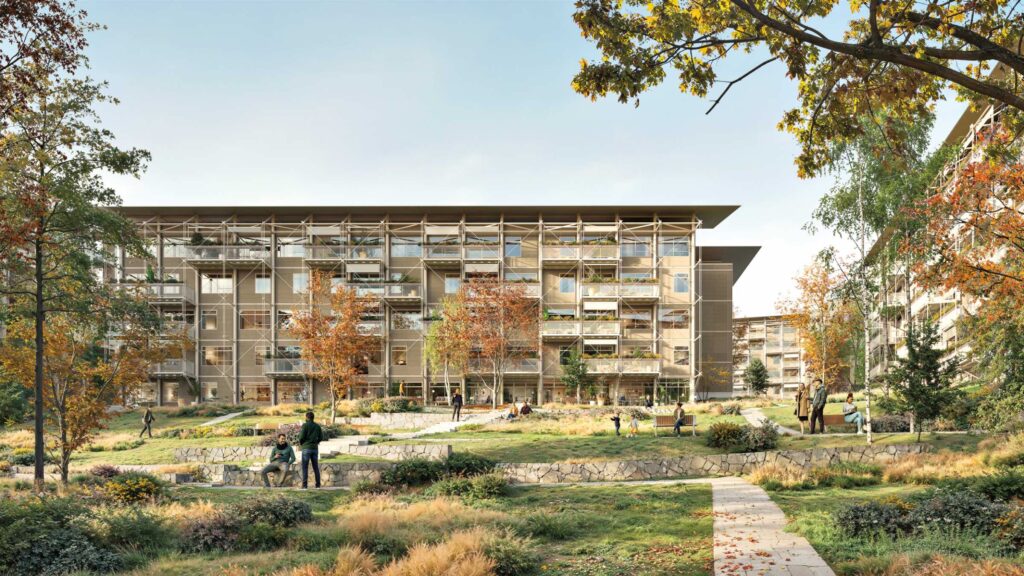 Timber Housing: Modern apartment buildings with large balconies overlook landscaped grounds with people walking, sitting, and biking among autumn trees and grassy areas.