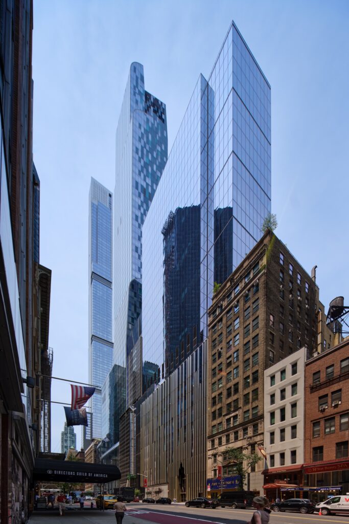 Tall modern glass skyscrapers rise behind older brick buildings along a busy city street, with cars and people visible in the foreground—just blocks away from the striking architecture of the Lucas Museum of Narrative Art.