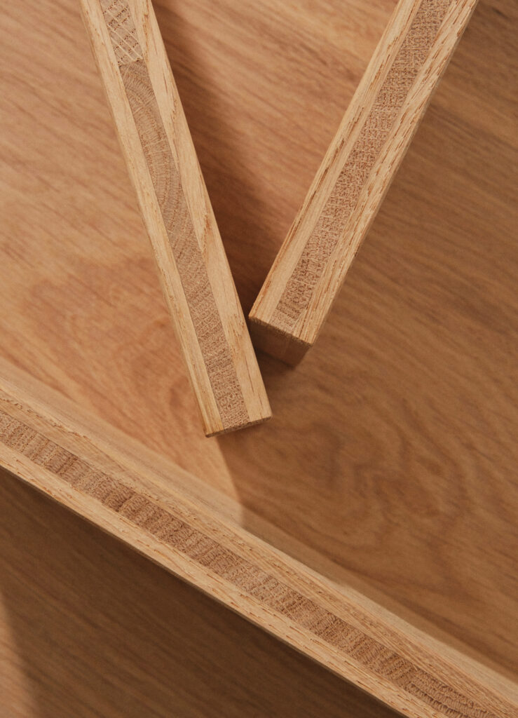 Birds-eye view of a wooden surface with two wood rods forming a "V" shape across its surface.
