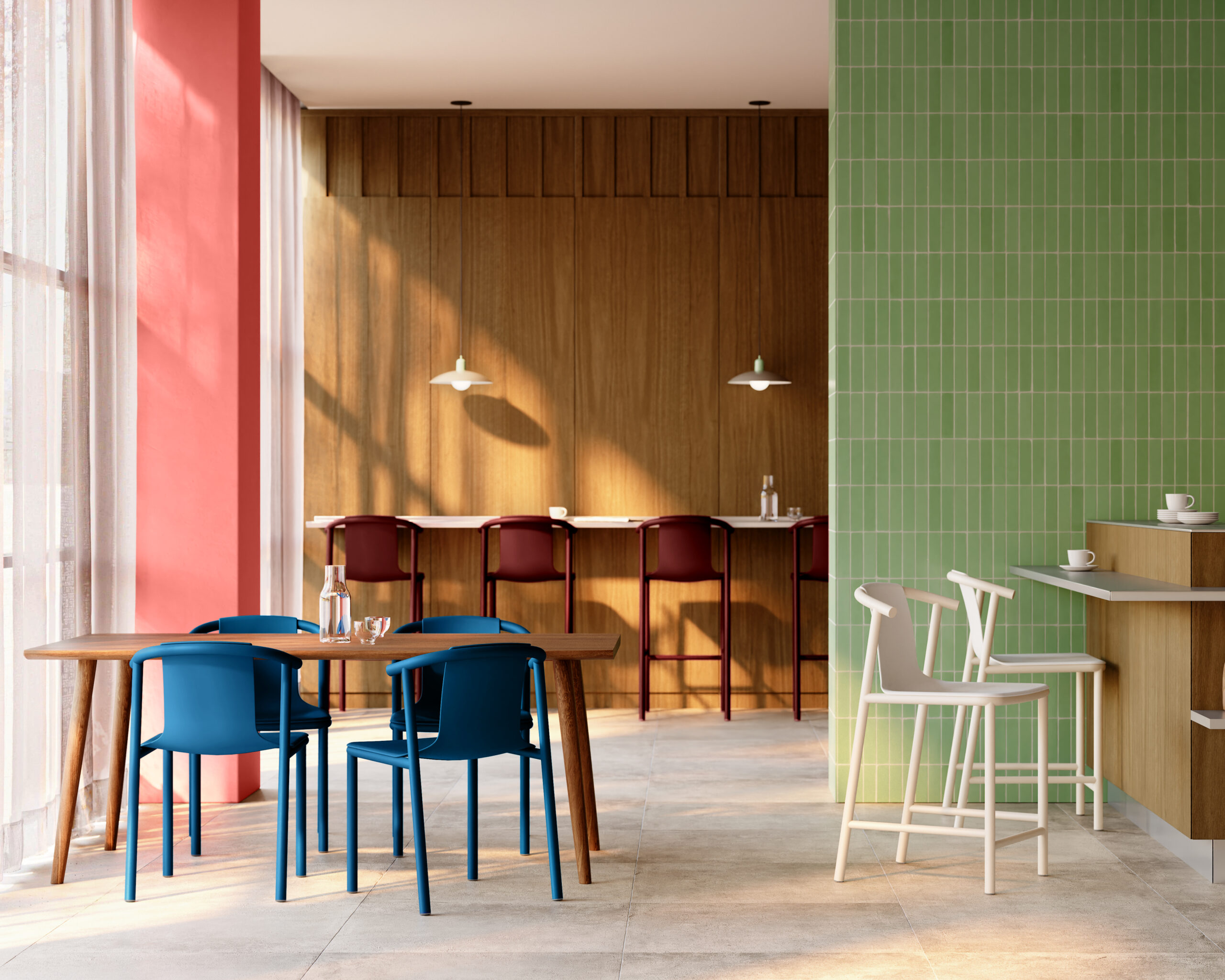 A modern café interior features blue and white chairs, wooden tables, a green-tiled wall, and a long counter with red stools. Sunlight streams in through large windows with sheer curtains.