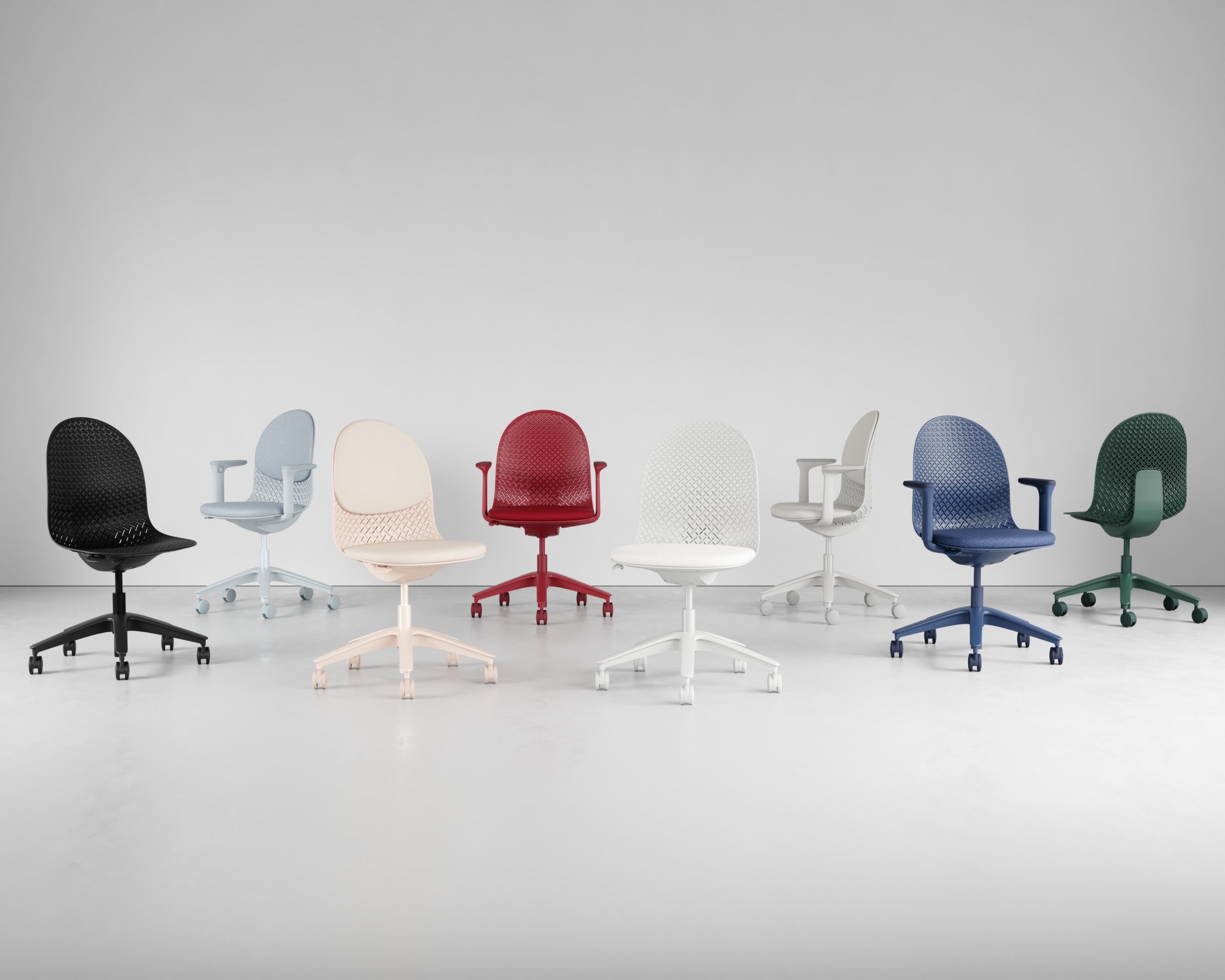 Eight office chairs in various colors including black, light blue, beige, red, white, dark blue, and green are arranged in a row against a plain light gray background.