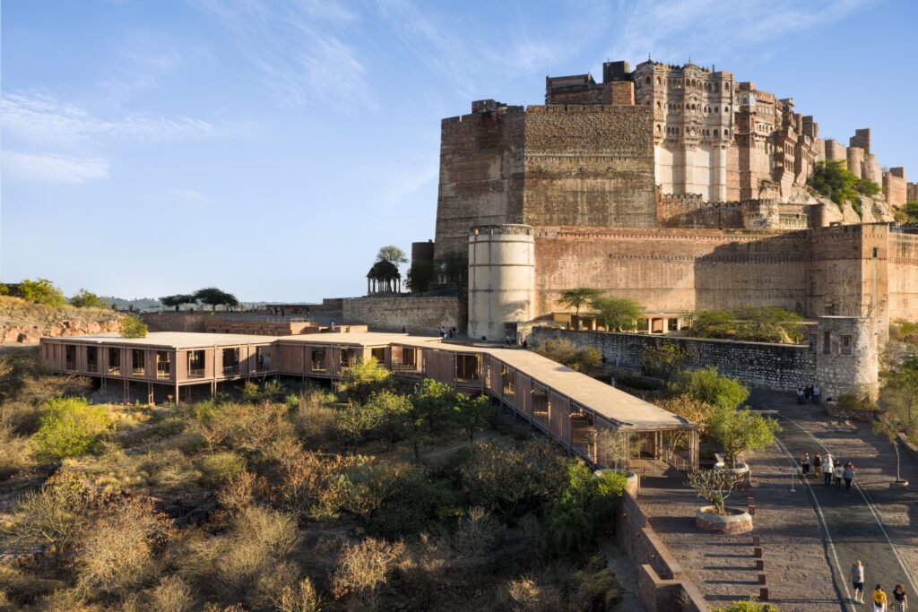 Mehrangarh Fort sits atop a rocky hill overlooking the Barbara and Gerson Bakar Gateway at UC Berkeley, with a stone path leading to the entrance.