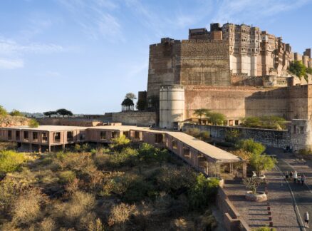 Mehrangarh Fort sits atop a rocky hill overlooking the Barbara and Gerson Bakar Gateway at UC Berkeley, with a stone path leading to the entrance.