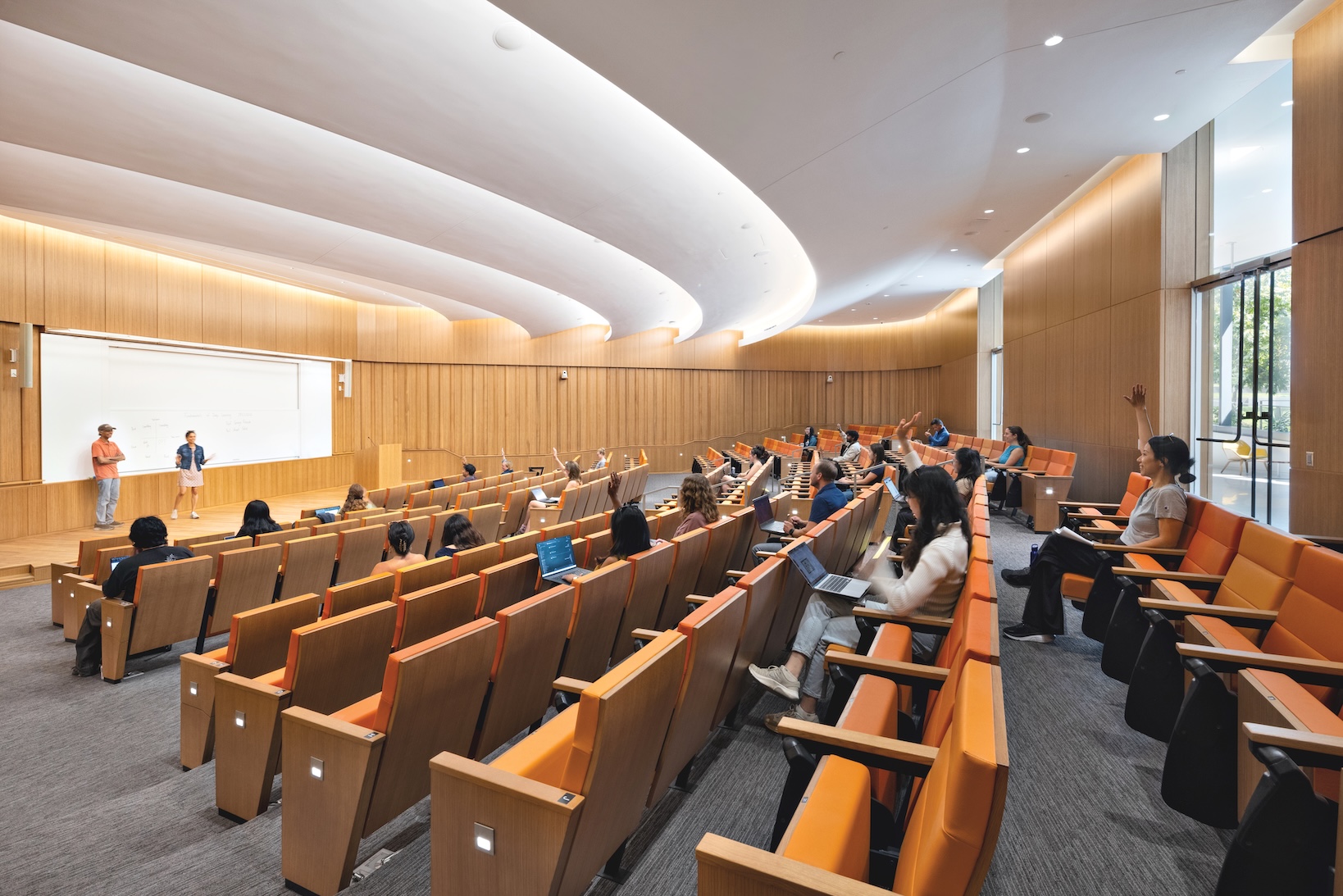 A Lucas Museum of Narrative Art lecture in progress with a professor at the front and several students with their hands raised.