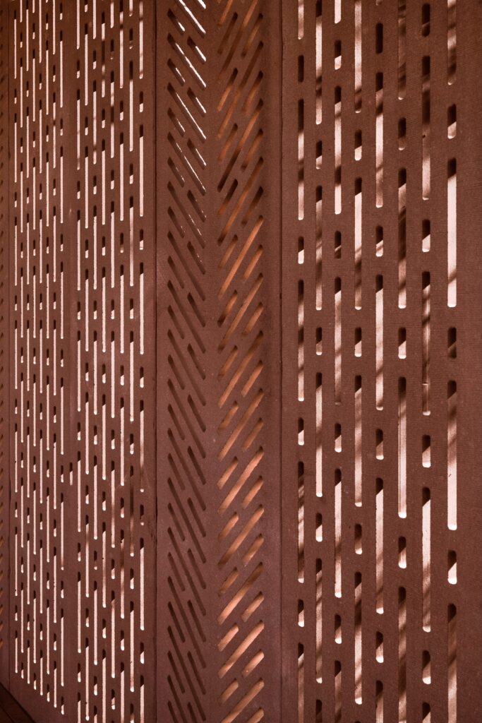 Three vertical panels with geometric, slot-cut patterns at the Barbara and Gerson Bakar Gateway.