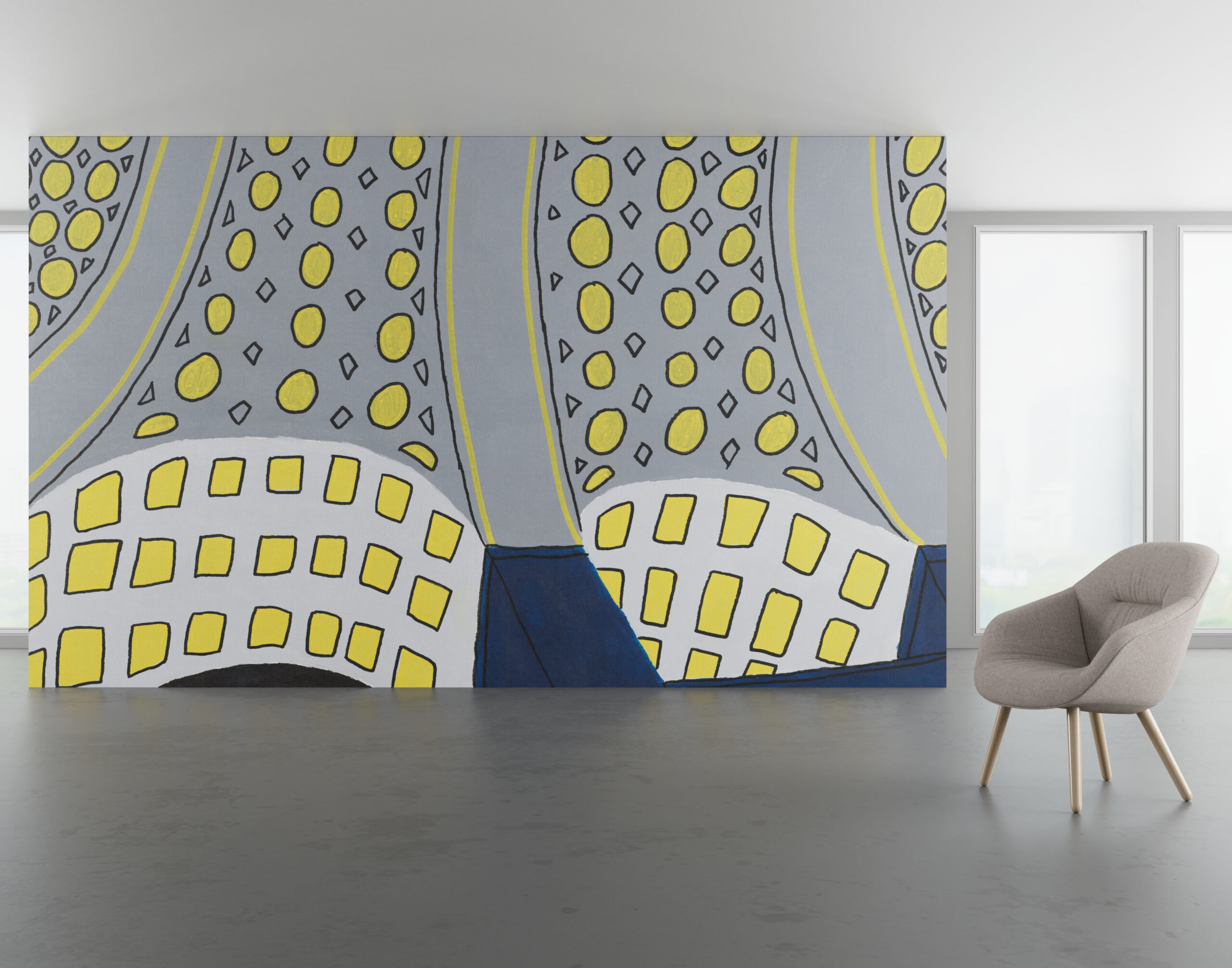 A large wall mural featuring yellow shapes on a grey background sits behind a grey upholstered armchair.