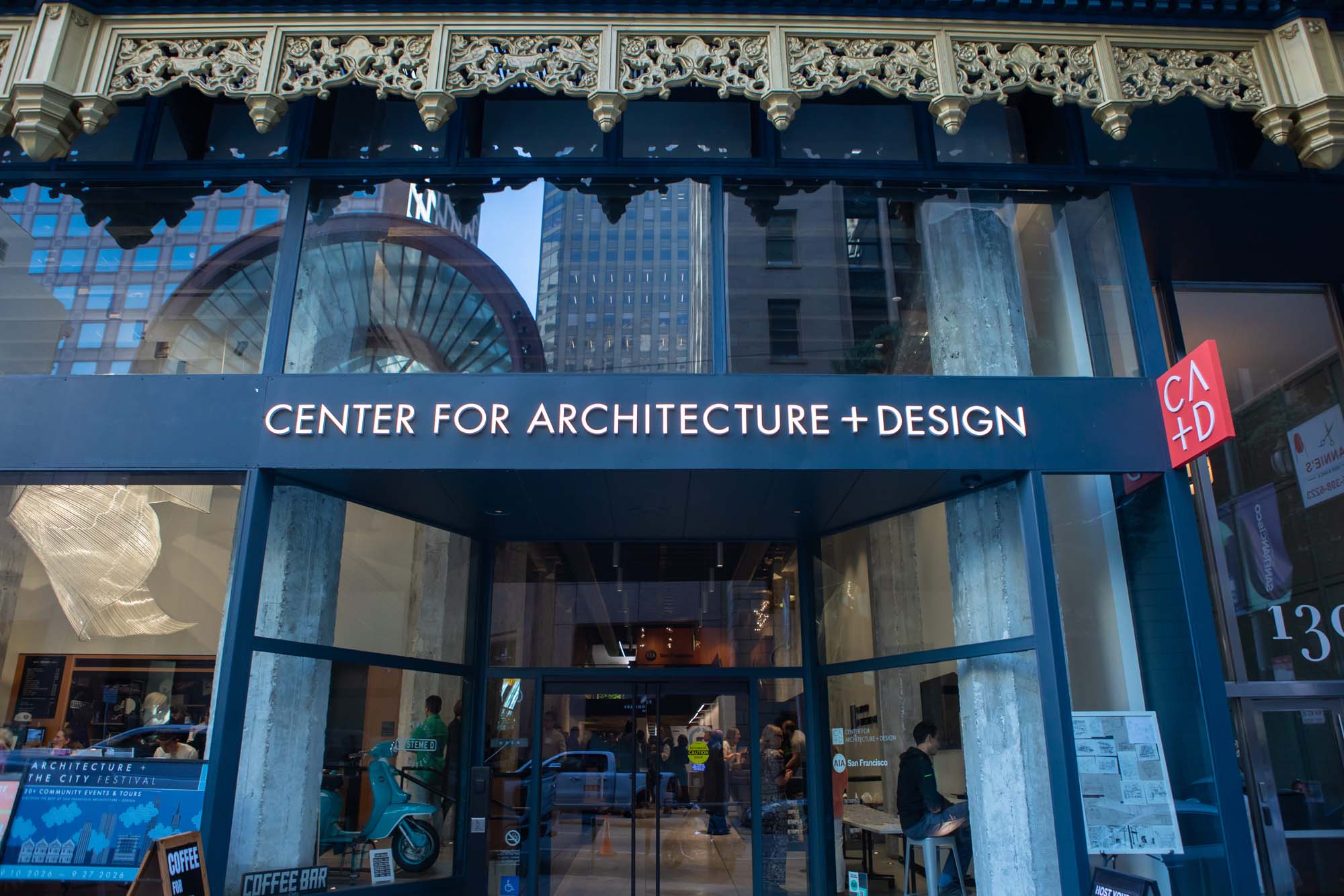 The storefront of the Center for Architecture + Design in San Francisco, featuring glass windows and a prominent sign above the entrance.