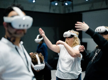 A group of people wearing virtual reality headsets at MIT Future Fest in an indoor space.
